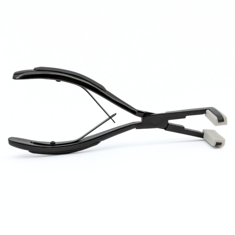 Tape-In Press Application Pliers Ensure every tape-in extension is flawlessly secured with the Tape-In Press Application Pliers. These high-quality pliers distribute even pressure across each bond, dramatically improving adhesion and extension longevity. With a durable design and anti-slip grip, they’re essential for any professional stylist. Key Features: Enhanced Adhesion: Firmly presses tape-in bonds for a long-lasting hold. Smooth Silicone Pads: Protect extensions from damage while ensuring a flat, seamless finish. Durable Stainless Steel: Built to withstand daily salon use. Comfortable Cushioned Handles: Provides a secure, comfortable grip for extended use. Sleek Matte Black Finish: Adds a touch of style to your professional tools. Specifications: Length: 8 inches Achieve sleek and secure tape-in installations with the Tape-In Press Application Pliers, combining durability and functionality in one indispensable tool. Important Notice:This item is final sale and non-returnable. Please confirm compatibility with your professional needs before purchasing.