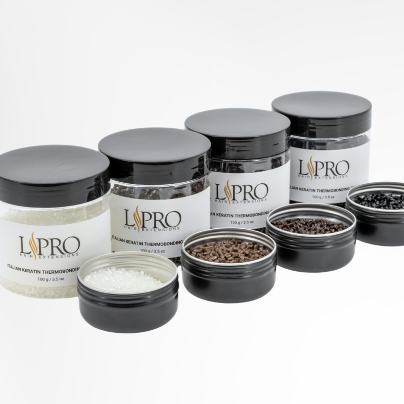 A row of 4 medium size jars and 4 small jars of keratin grain for hair extensions