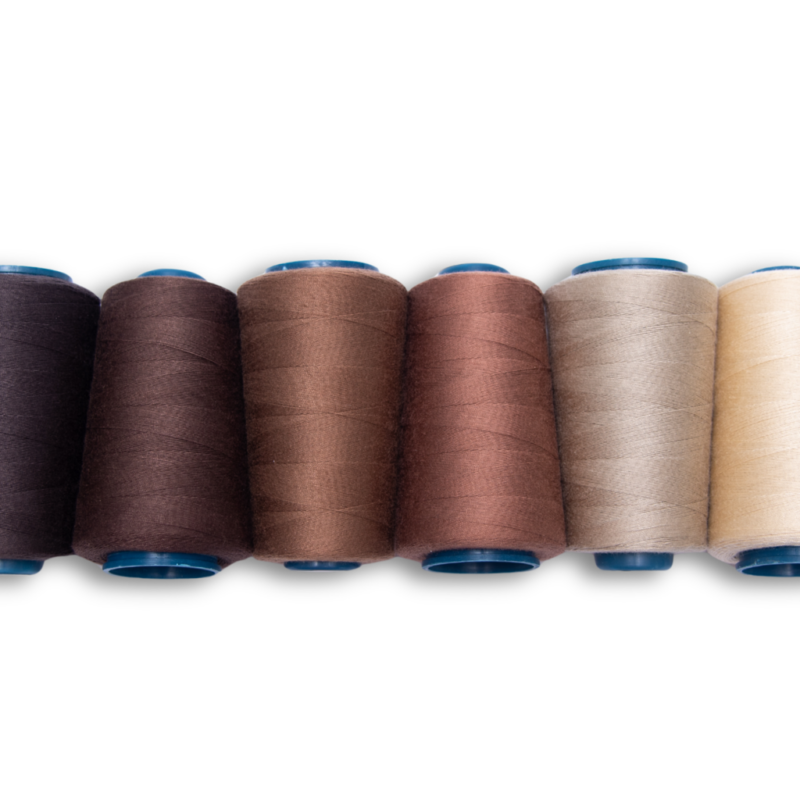 6 spools of cotton thread for hair extensions, all in different colors, lined up next to each other