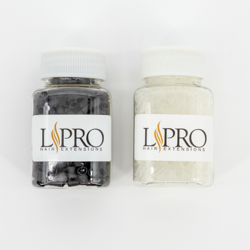 2 jars of shrinky link tubes for hair extensions. One jar has clear tubes and the other jar has black tubes